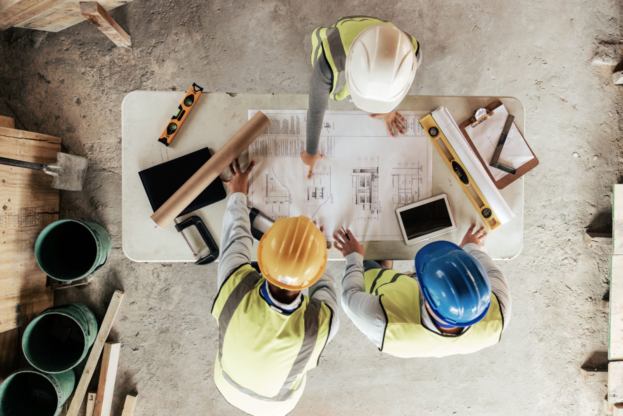 Construction workers reviewing building plans together.